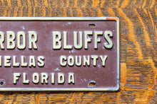 Load image into Gallery viewer, Harbor Bluffs Florida Booster License Plate Vintage FL Brown Wall Decor
