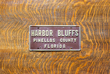 Load image into Gallery viewer, Harbor Bluffs Florida Booster License Plate Vintage FL Brown Wall Decor
