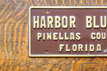 Load image into Gallery viewer, Harbor Bluffs Florida Booster License Plate Vintage FL Brown Wall Decor
