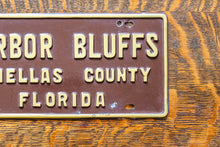 Load image into Gallery viewer, Harbor Bluffs Florida Booster License Plate Vintage FL Brown Wall Decor
